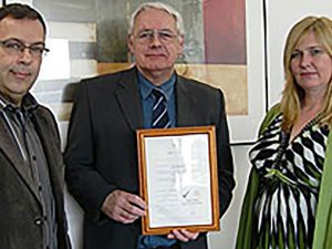 3 people posing with a certificate in London