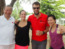 2 men and 2 women smiling and drinking during a petanque tournament