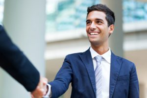 Man in suit handshaking with somebody