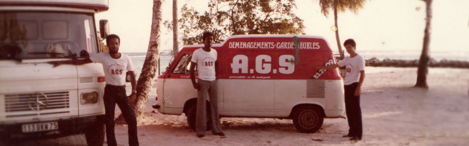 AGS Guadeloupe 3 men posing with movers trucks in the 70s