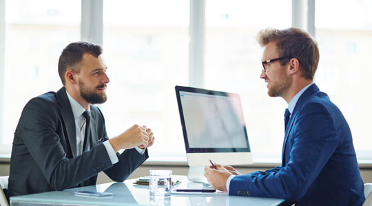 2 men having an interview or meeting in an office