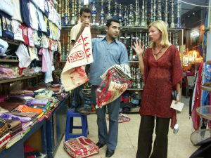 Woman negociating clothes and tissus in a shop