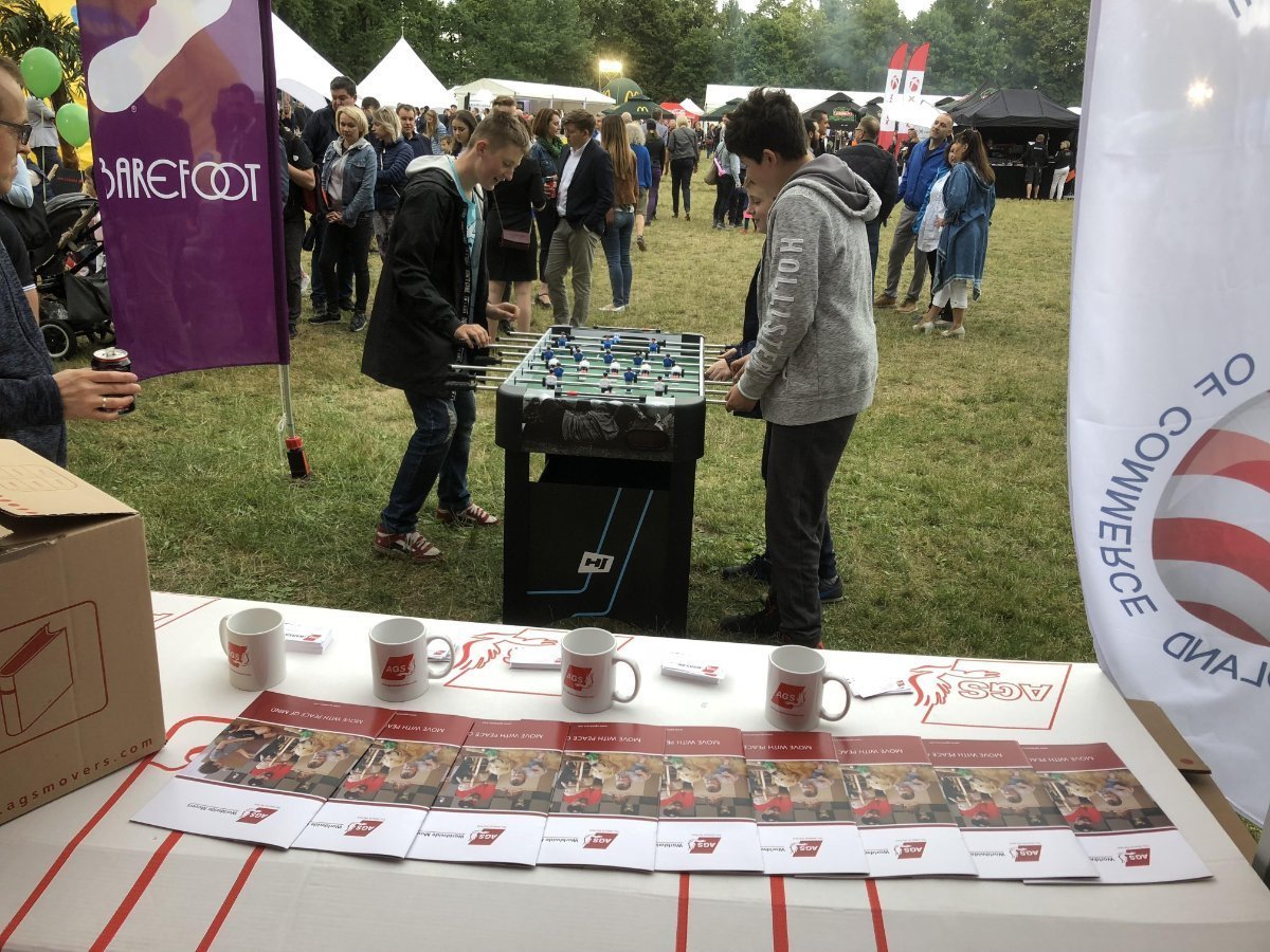 Kids playing foosball at a picnic.