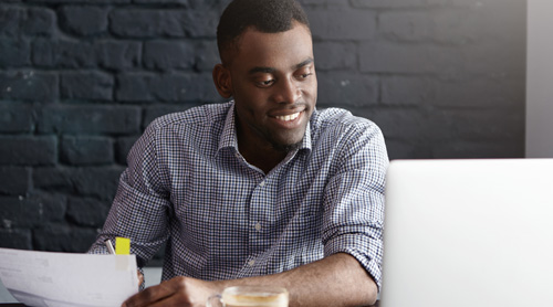 Employee at desk looking at computer